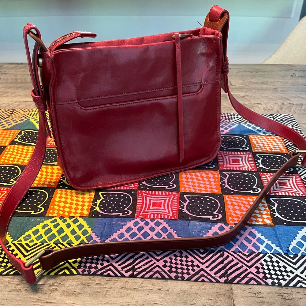 Cranberry colored small Hobo cross body bag. Beautiful patina leather shines.